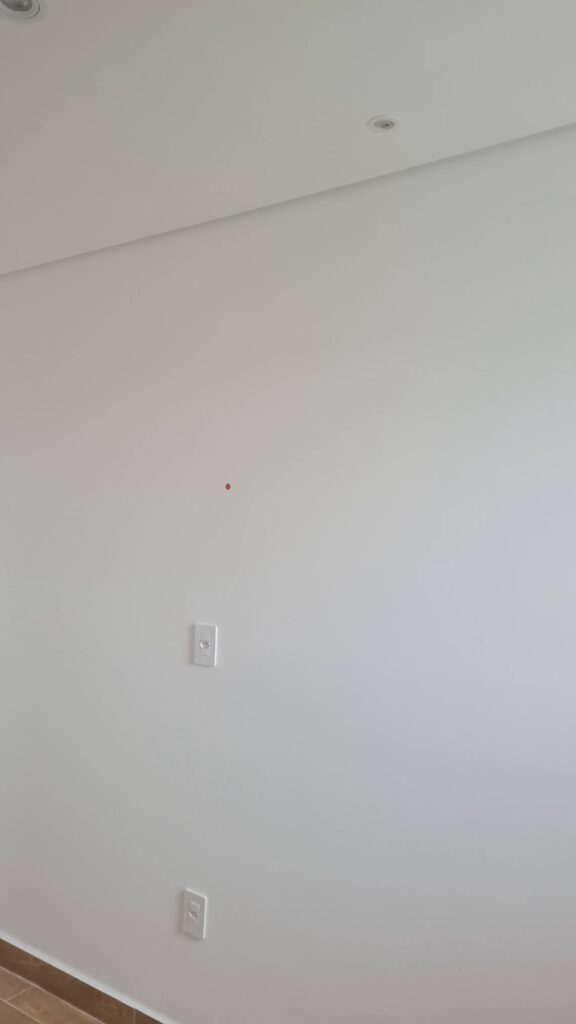 Parede com tomadas e pontos elétricos em apartamento novo durante vistoria técnica.
